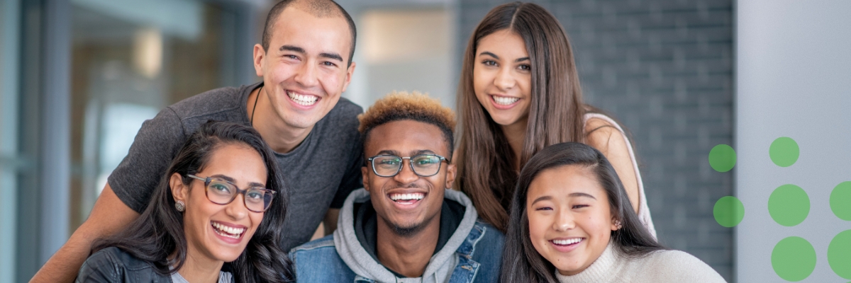 Five students gathered together and smiling.